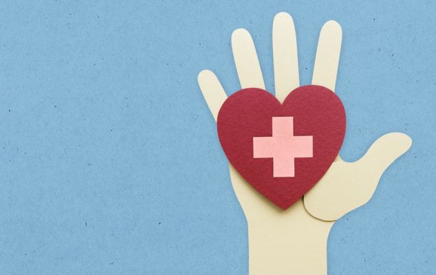 Construction paper to show a hand holding a cartoon heart