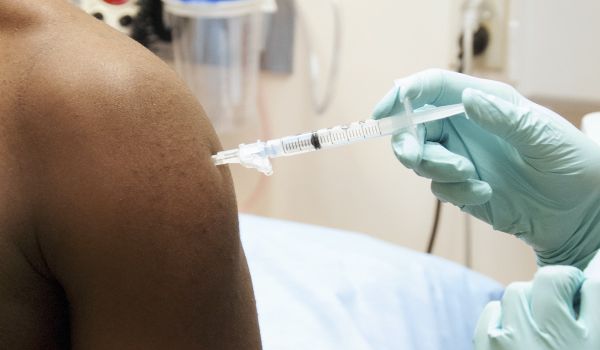 Man gets a vaccine in his left arm