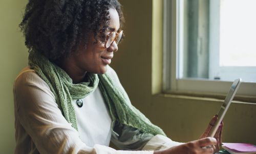 woman holding iPad on a video call